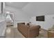 Spacious living room featuring a plush leather sofa, modern TV, and charming decor elements at 105 Suffolk Pl, Fayetteville, GA 30215