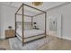Serene bedroom features a four-poster bed, hardwood floors, and an ensuite bathroom entrance at 105 Suffolk Pl, Fayetteville, GA 30215
