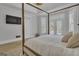 Bedroom with a four-poster bed, wood floors, and plenty of natural light from the adjacent french doors at 105 Suffolk Pl, Fayetteville, GA 30215