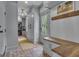 Mudroom with grey cabinets, wood countertop, brick flooring and stacked washer and dryer at 105 Suffolk Pl, Fayetteville, GA 30215