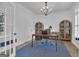 Bright office features hardwood floors, chandelier lighting, and custom built in shelving at 105 Suffolk Pl, Fayetteville, GA 30215