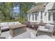 Inviting outdoor patio features cushioned seating, a fire pit table, and manicured landscaping at 105 Suffolk Pl, Fayetteville, GA 30215