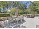 Backyard with an outdoor dining area, lush green grass, and professional landscaping at 105 Suffolk Pl, Fayetteville, GA 30215