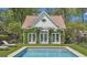 Pool house surrounded by lush landscaping and a black fence at 105 Suffolk Pl, Fayetteville, GA 30215