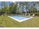 Backyard features a sparkling pool with surrounding lounge chairs for relaxation and enjoyment at 105 Suffolk Pl, Fayetteville, GA 30215