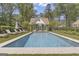 Backyard features a sparkling pool with a pool house and surrounding lounge chairs for relaxation at 105 Suffolk Pl, Fayetteville, GA 30215