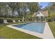 Backyard features a sparkling pool with a pool house and surrounding lounge chairs for relaxation at 105 Suffolk Pl, Fayetteville, GA 30215