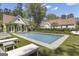 Backyard features a sparkling pool with a pool house and surrounding lounge chairs for relaxation at 105 Suffolk Pl, Fayetteville, GA 30215