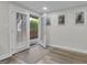 White room with double glass doors leading to a brick patio and a grey rug on the floor at 105 Suffolk Pl, Fayetteville, GA 30215
