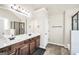 Well-lit bathroom boasts a double vanity, shower and dark wood cabinets, plus a large mirror at 9929 Musket Ridge Cir, Jonesboro, GA 30238