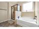 Stylish bathroom offers a walk-in shower, relaxing soaking tub and a bright window at 9929 Musket Ridge Cir, Jonesboro, GA 30238
