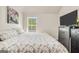 Bright bedroom featuring a bed, natural light from a window, and a TV on a dresser at 9929 Musket Ridge Cir, Jonesboro, GA 30238