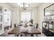 Bright dining room with stylish chandelier, a large wooden table and modern decor at 9929 Musket Ridge Cir, Jonesboro, GA 30238