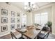 Bright dining room features stylish chandelier, large wood table, and decorative wall art at 9929 Musket Ridge Cir, Jonesboro, GA 30238