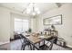 This dining room offers a modern chandelier, wooden table, and an accent bench at 9929 Musket Ridge Cir, Jonesboro, GA 30238