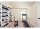 Bright exercise room features workout equipment, storage shelves and a window for natural light at 9929 Musket Ridge Cir, Jonesboro, GA 30238