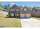 Beautiful brick home with a two-car garage and well-manicured lawn at 9929 Musket Ridge Cir, Jonesboro, GA 30238