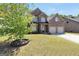 Brick home with a well-maintained lawn and mature landscaping at 9929 Musket Ridge Cir, Jonesboro, GA 30238