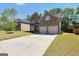 Charming brick home with a spacious driveway and attached two-car garage at 9929 Musket Ridge Cir, Jonesboro, GA 30238