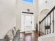 Welcoming foyer featuring hardwood floors, high ceilings, and a staircase at 9929 Musket Ridge Cir, Jonesboro, GA 30238