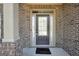 Close-up of a stylish front door with glass panel and sidelights at 9929 Musket Ridge Cir, Jonesboro, GA 30238