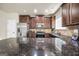 Spacious kitchen with stainless steel appliances, dark granite countertops and hardwood floors at 9929 Musket Ridge Cir, Jonesboro, GA 30238