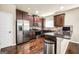 Modern kitchen with stainless steel appliances, dark wood cabinets, and hardwood floors at 9929 Musket Ridge Cir, Jonesboro, GA 30238