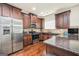 Well-lit kitchen featuring stainless steel appliances, granite countertops, and wooden cabinets at 9929 Musket Ridge Cir, Jonesboro, GA 30238