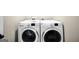 Efficient laundry room with high-end, front-load washer and dryer units side by side at 9929 Musket Ridge Cir, Jonesboro, GA 30238