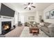 Spacious living room with a cozy fireplace, plush sofas, and natural lighting at 9929 Musket Ridge Cir, Jonesboro, GA 30238