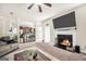 Open-concept living room with fireplace, seamless transition to the kitchen, and cozy furnishings at 9929 Musket Ridge Cir, Jonesboro, GA 30238