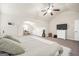 Spacious bedroom suite includes a ceiling fan, large bed and living space with a TV at 9929 Musket Ridge Cir, Jonesboro, GA 30238
