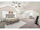 Expansive bedroom with vaulted ceiling, ceiling fan, and a cozy sitting area with a desk at 9929 Musket Ridge Cir, Jonesboro, GA 30238
