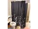 Bathroom featuring a toilet and shower with black and white curtain at 3464 Kingswood Trl, Decatur, GA 30034