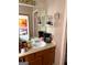 Bathroom vanity with a single sink, mirror, and wicker shelf with coffee maker at 3464 Kingswood Trl, Decatur, GA 30034