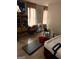 Bedroom with hardwood floors, natural light, and disorganized furniture at 3464 Kingswood Trl, Decatur, GA 30034