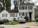 Two-story house with white siding, black shutters, a driveway and yard in need of some TLC at 3464 Kingswood Trl, Decatur, GA 30034