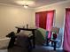 A room featuring a unique triangular table with bench seating and red curtains at 3464 Kingswood Trl, Decatur, GA 30034