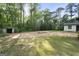 Expansive backyard with ample space, outbuilding, trees, and sunny skies at 389 Rosser Rd, Mcdonough, GA 30252