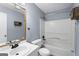 A well-lit bathroom features a shower-tub combo, sink, toilet, and modern fixtures at 389 Rosser Rd, Mcdonough, GA 30252