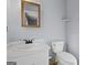 Bathroom offers a white vanity, framed mirror, and a toilet at 389 Rosser Rd, Mcdonough, GA 30252