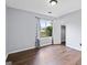 Bedroom with wood-look floors, gray walls, and window with blue patterned curtains at 389 Rosser Rd, Mcdonough, GA 30252