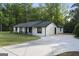 Single story home with long driveway, front porch, and well-maintained lawn at 389 Rosser Rd, Mcdonough, GA 30252