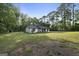 Cozy one-story home featuring a well-maintained lawn and a serene, wooded backdrop at 389 Rosser Rd, Mcdonough, GA 30252