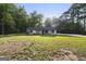 Charming one-story home with white siding, surrounded by lush greenery and a spacious front lawn at 389 Rosser Rd, Mcdonough, GA 30252