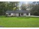 Charming single-story home featuring a well-manicured lawn and a classic design at 389 Rosser Rd, Mcdonough, GA 30252