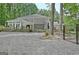 Backyard featuring a covered patio, stone counter, outdoor seating and a natural landscape at 135 Adams Park Dr, Fayetteville, GA 30214