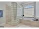 Beautiful bathroom featuring a large soaking tub, glass block, and marble floors at 135 Adams Park Dr, Fayetteville, GA 30214