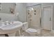 Cozy bathroom featuring a pedestal sink, glass-enclosed shower, and neutral tile, creating a comfortable space at 135 Adams Park Dr, Fayetteville, GA 30214