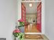 Inviting entryway with red doors, hardwood floors, and a welcome mat at 135 Adams Park Dr, Fayetteville, GA 30214
